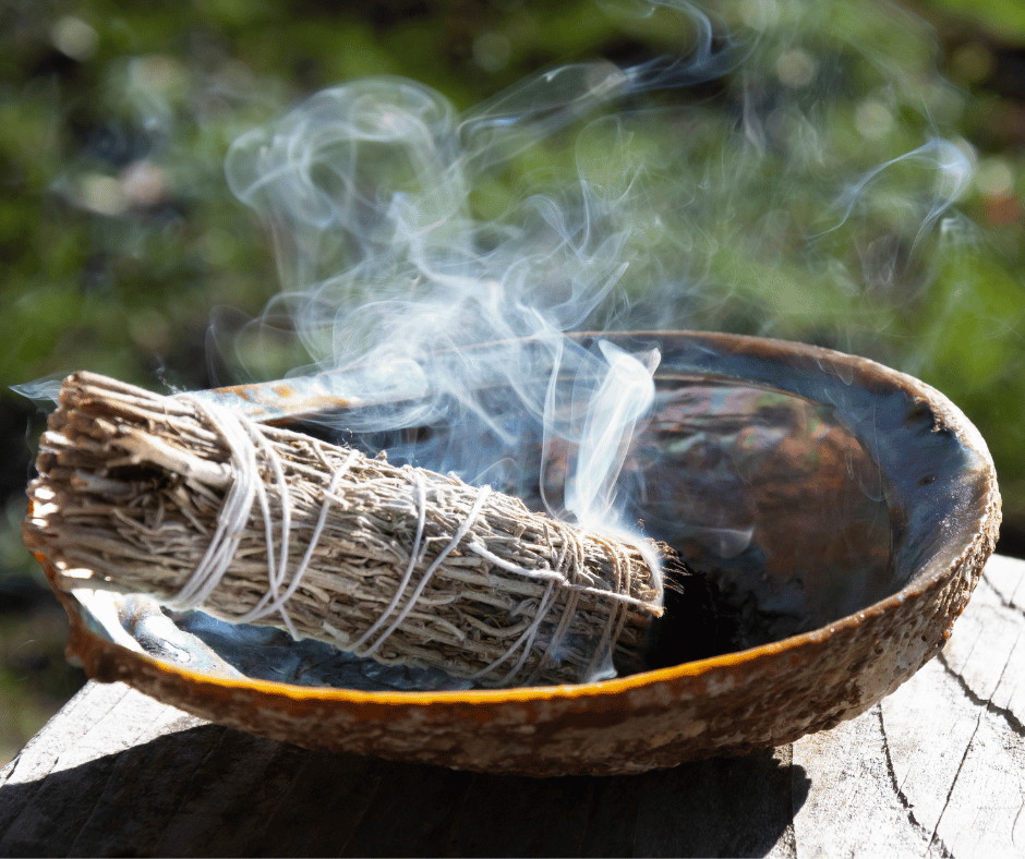 Smoking smudge stick in a bowl