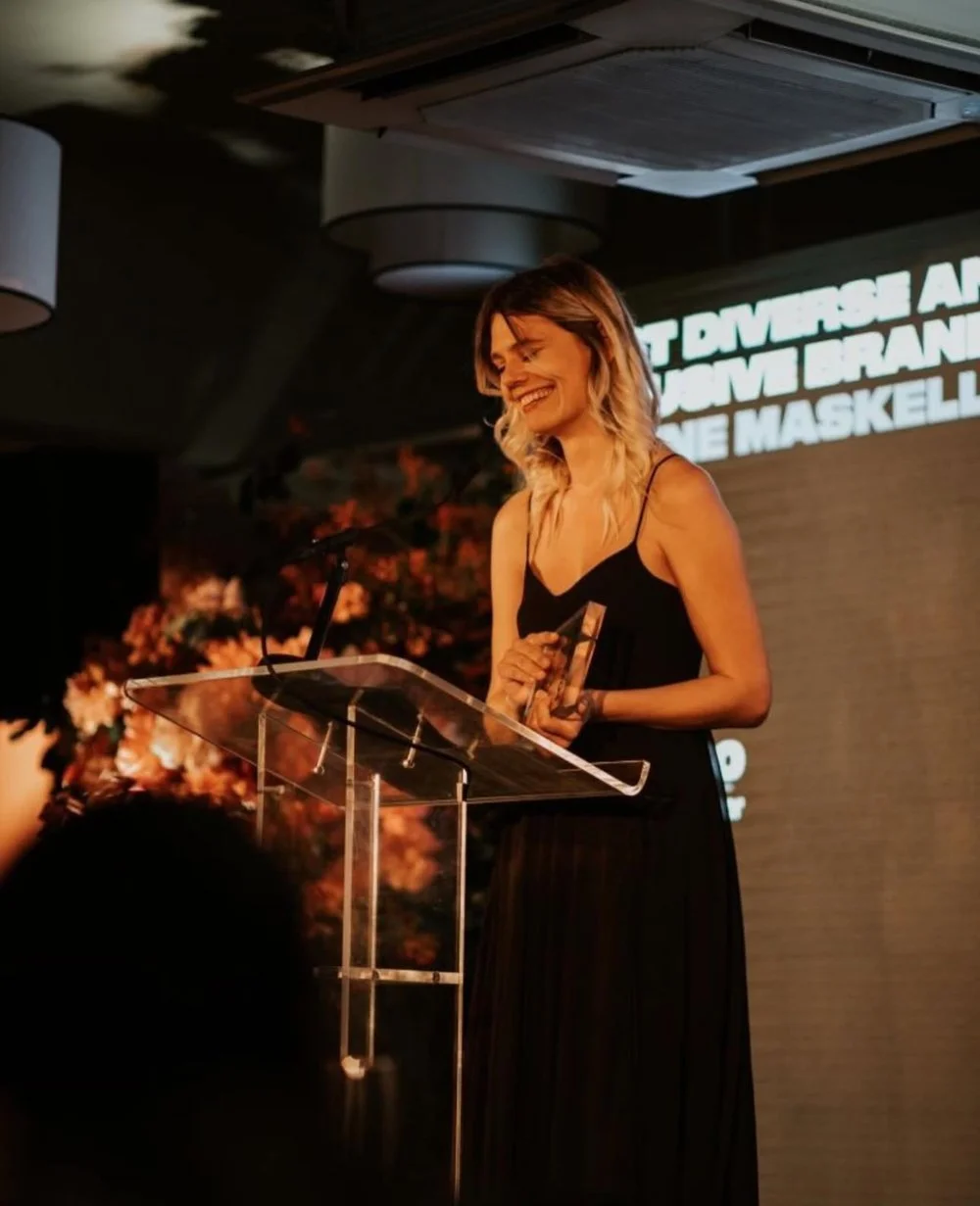 Leanne Maskell on stage accepting an award