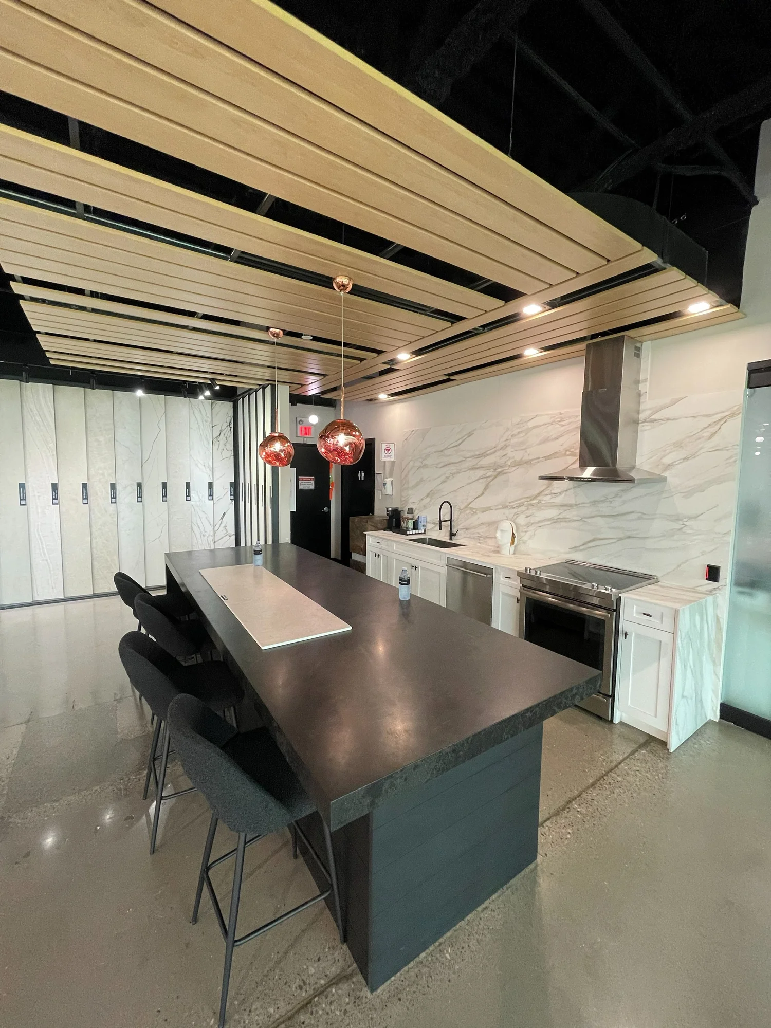 Caesarstone Vaughan showroom before the refresh, with a dark display island and white cabinetry