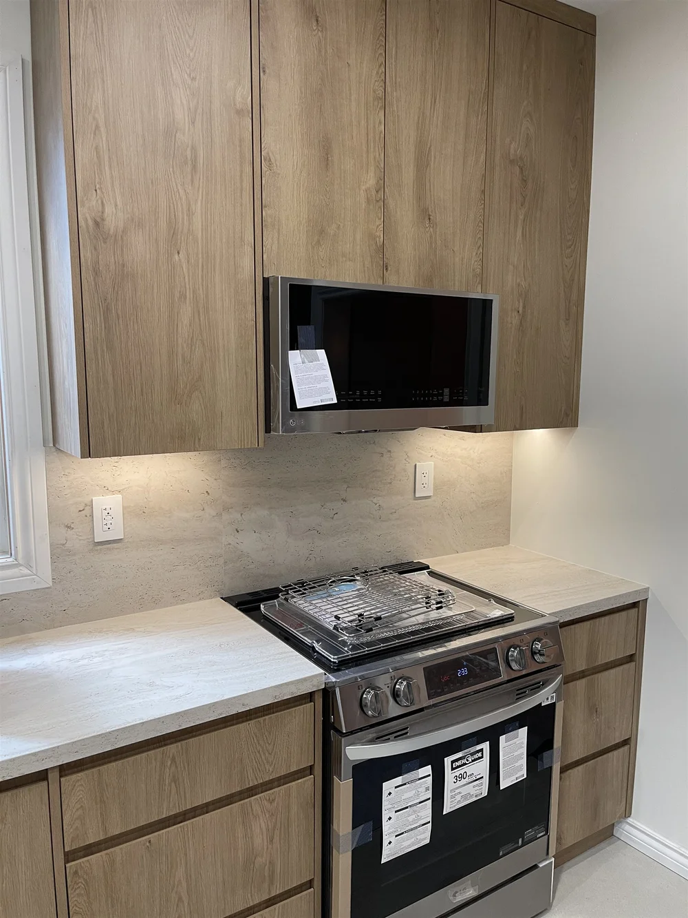 Range wall with wood-grain cabinets up to the ceiling in a Leslieville kitchen