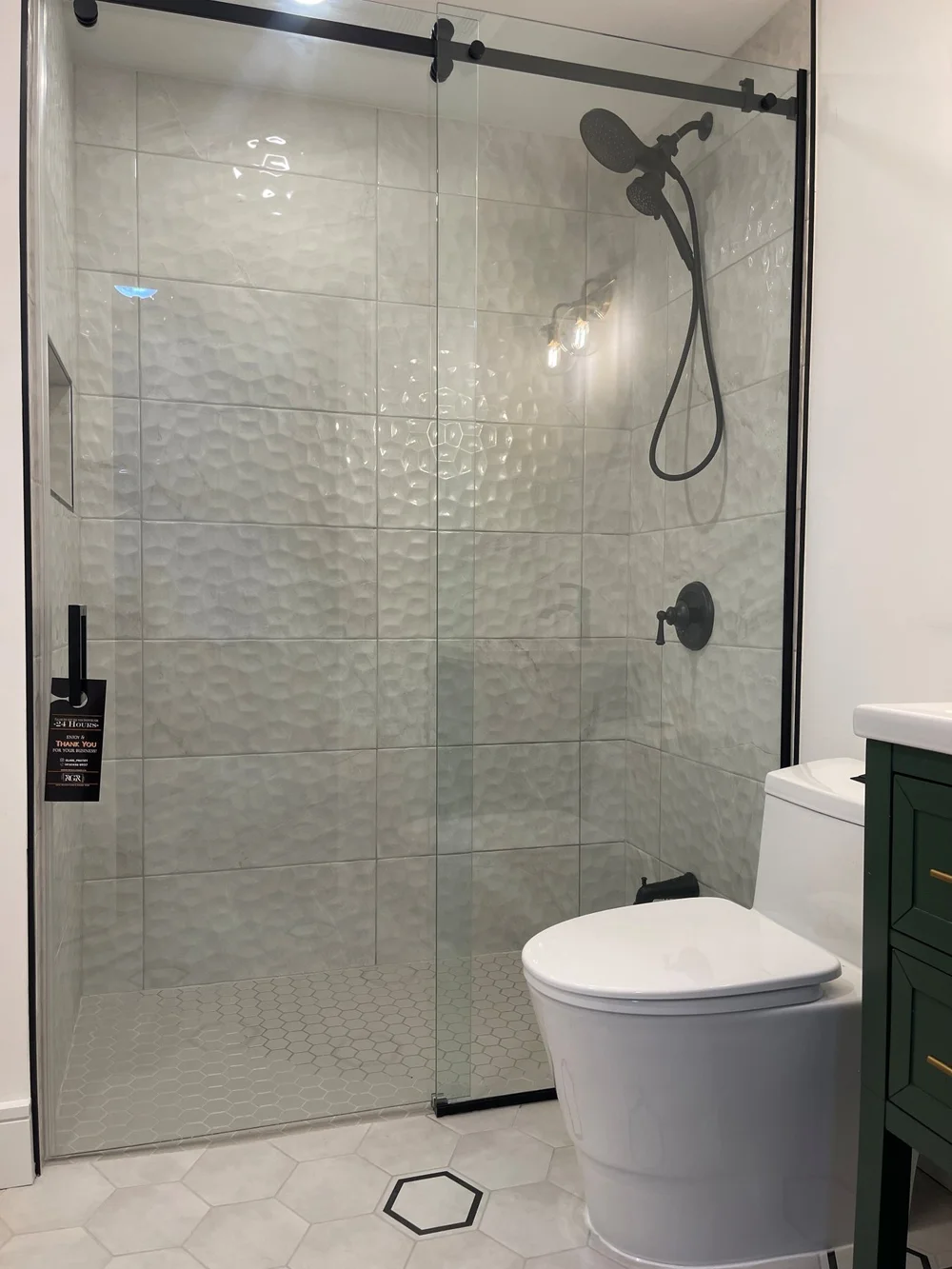 Hexagon floor tile at the new shower in the Etobicoke bathroom