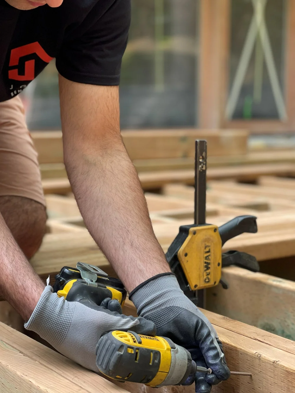 J Group crew framing a deck on a residential job site