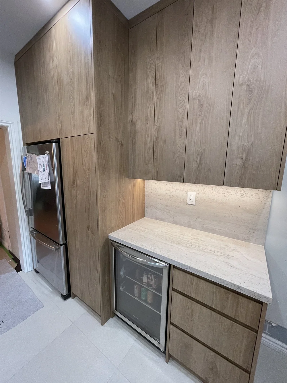 Tall pantry cabinet and built-in wine fridge in a Leslieville kitchen