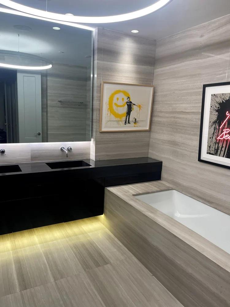 Luxury ensuite with floating black vanity and LED lighting