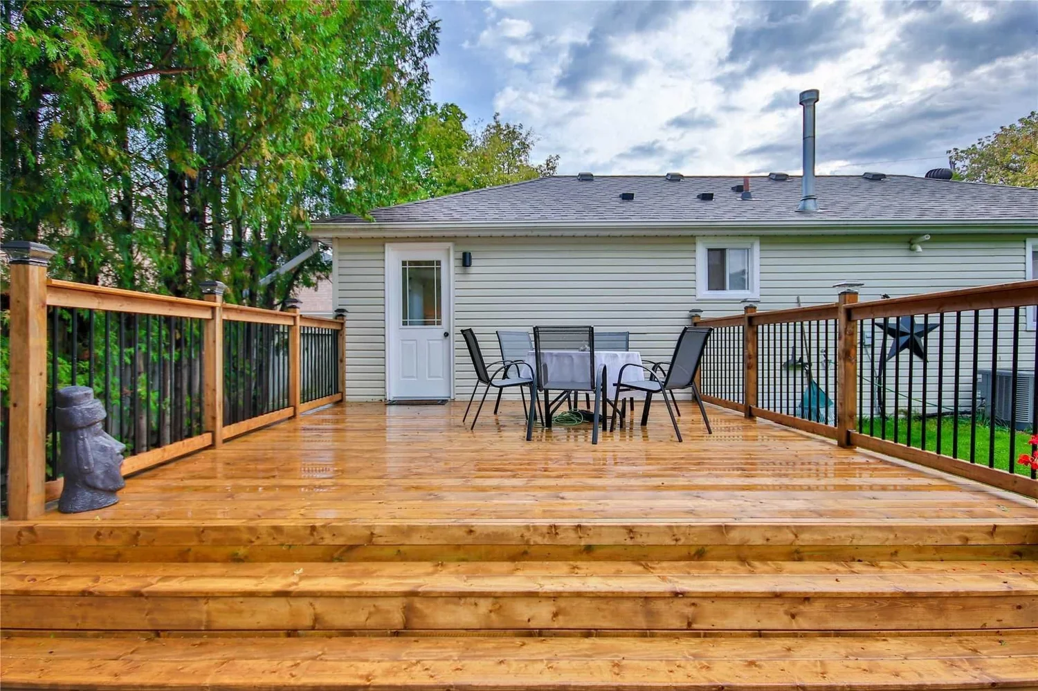 New wood deck with wide stairs and black metal railings