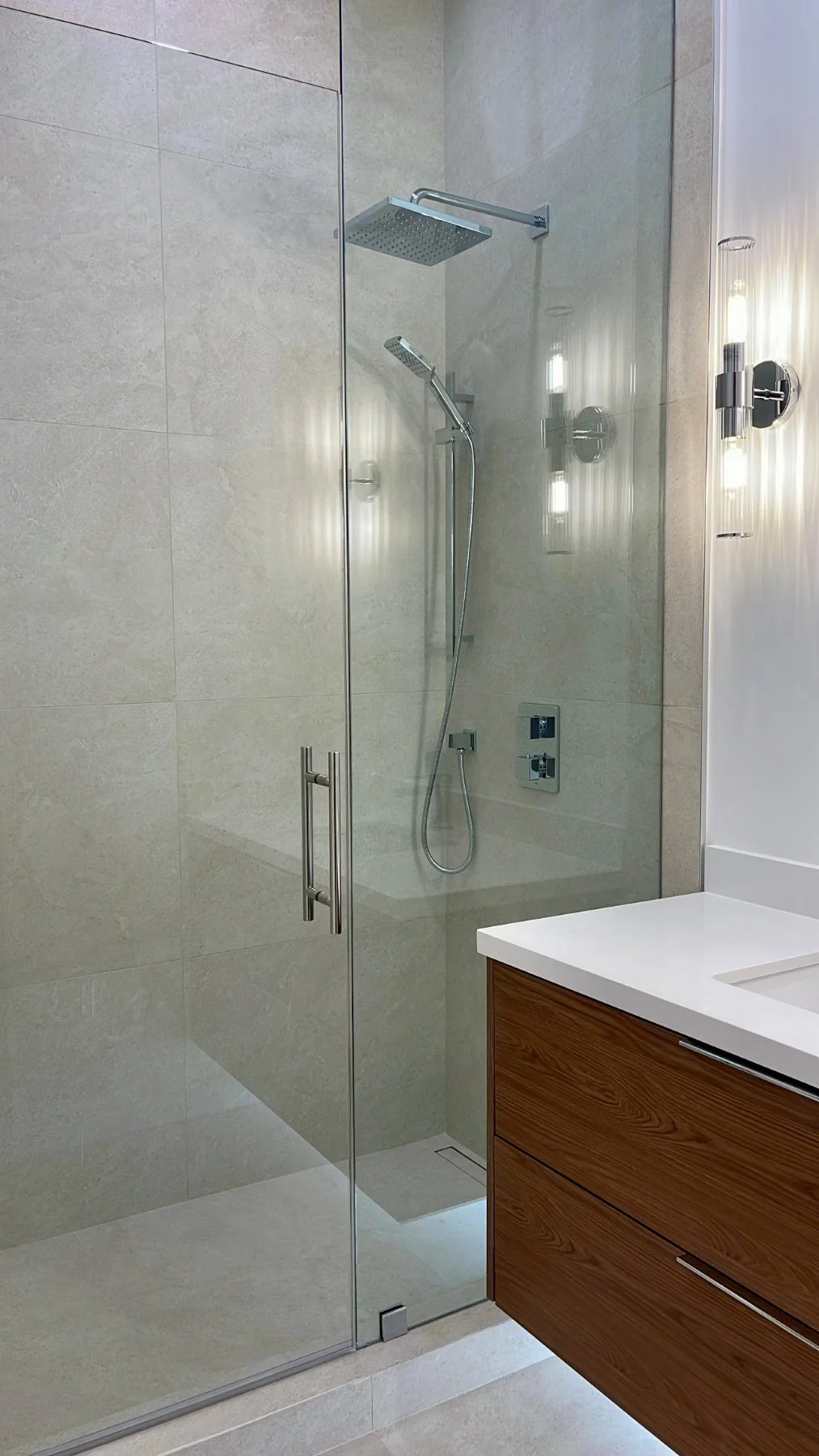 New frameless glass walk-in shower with a rain head at Toy Factory Lofts