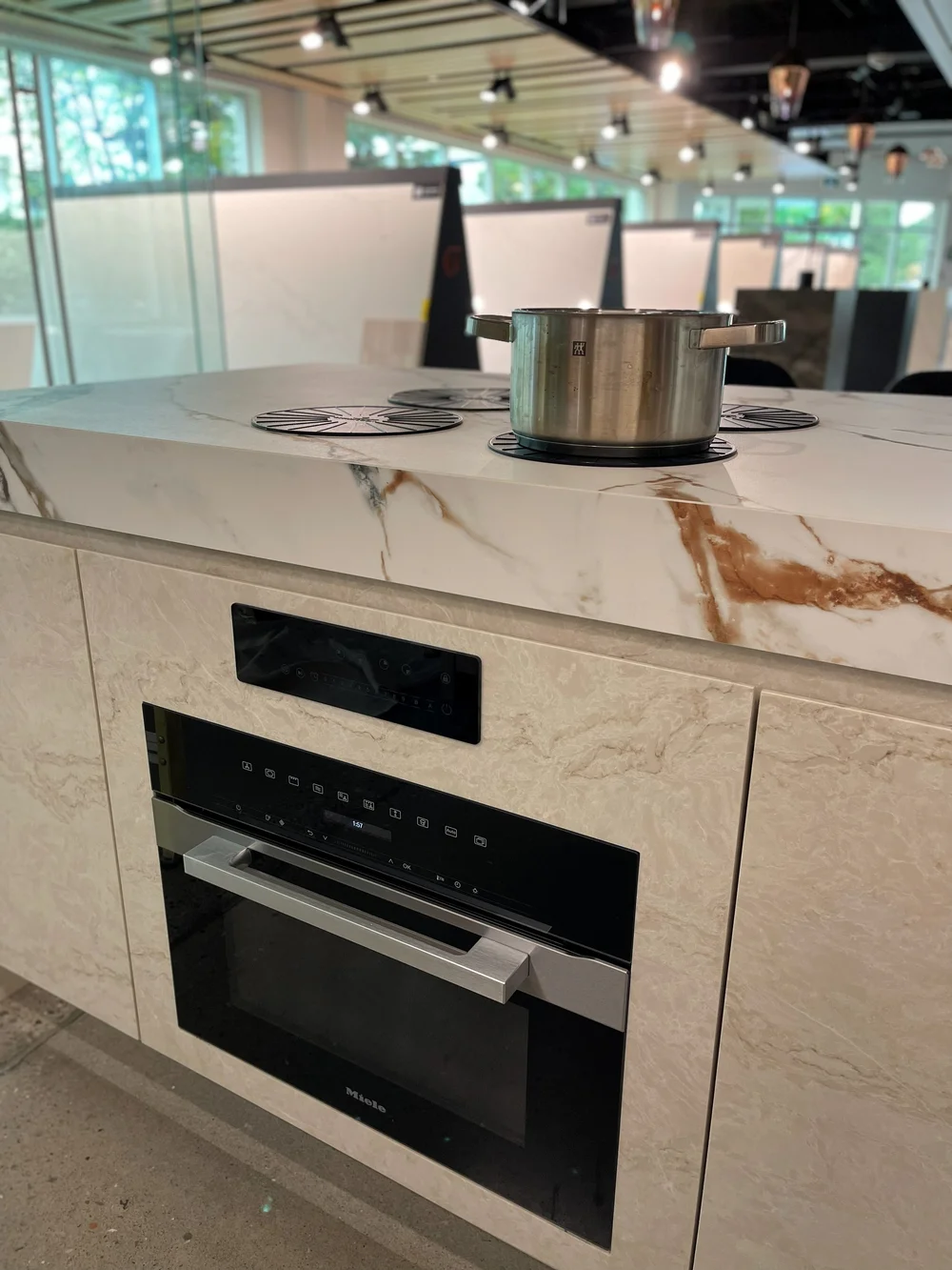 Induction cooking hidden under the stone counter of a Caesarstone display island