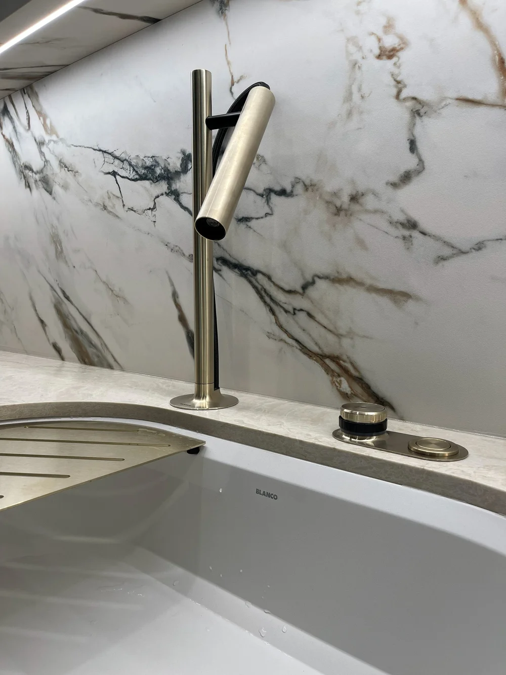 Close-up of a modern faucet and stone sink at the Caesarstone showroom