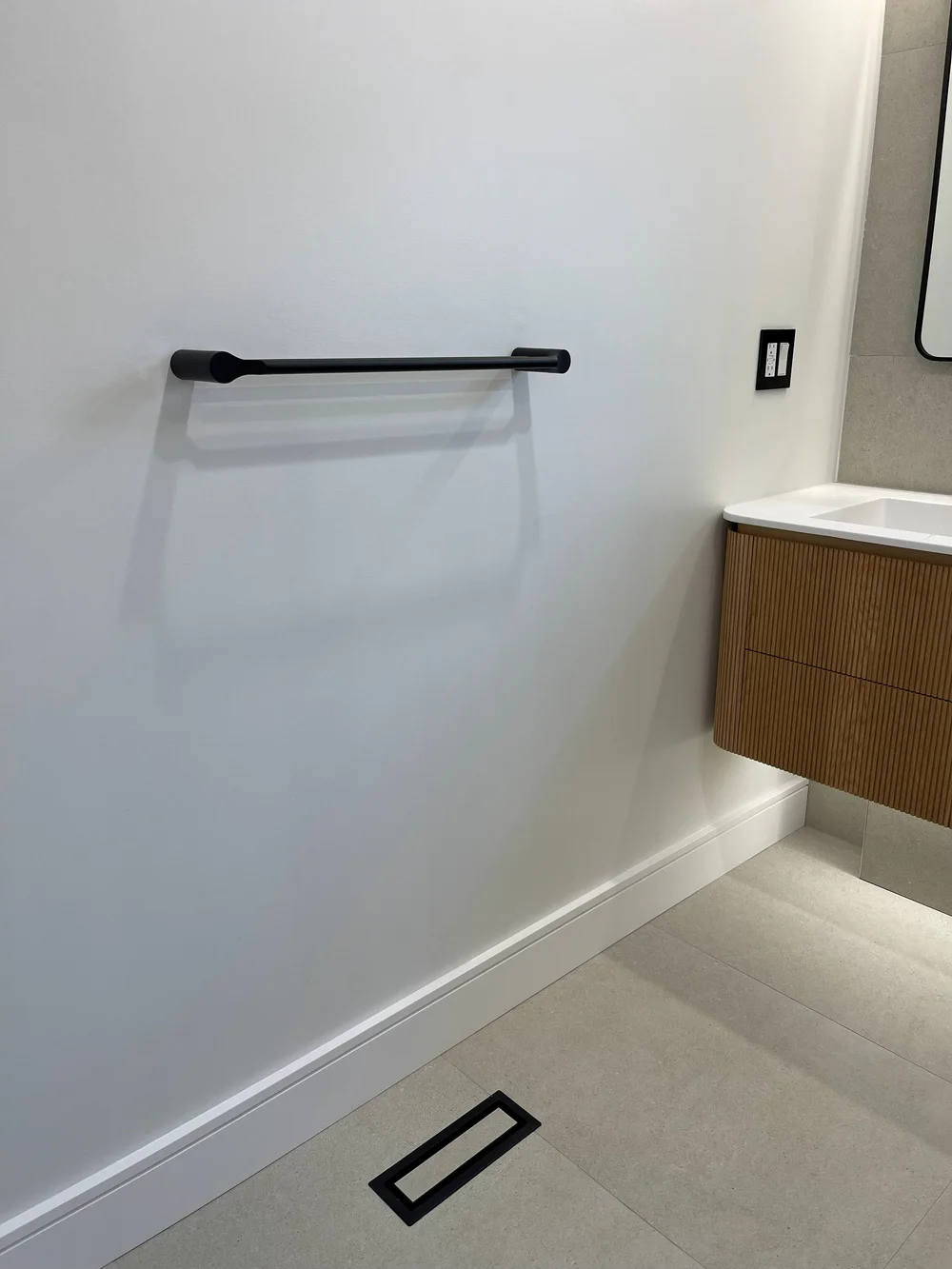 Linear drain in the floor and under-vanity lighting in the Vaughan bathroom