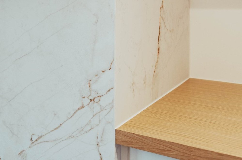 Marble surround meeting a wood cabinet top