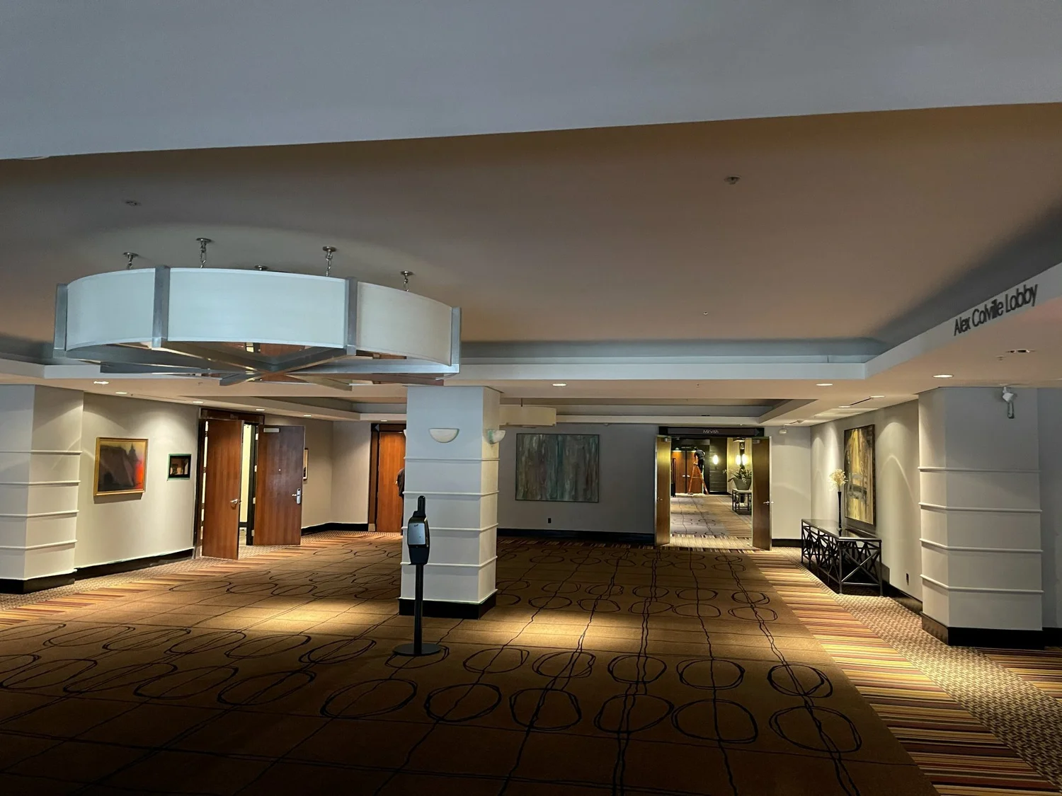 Toronto Congress Centre lobby before the renovation, with a dated ceiling fixture and brown patterned carpet