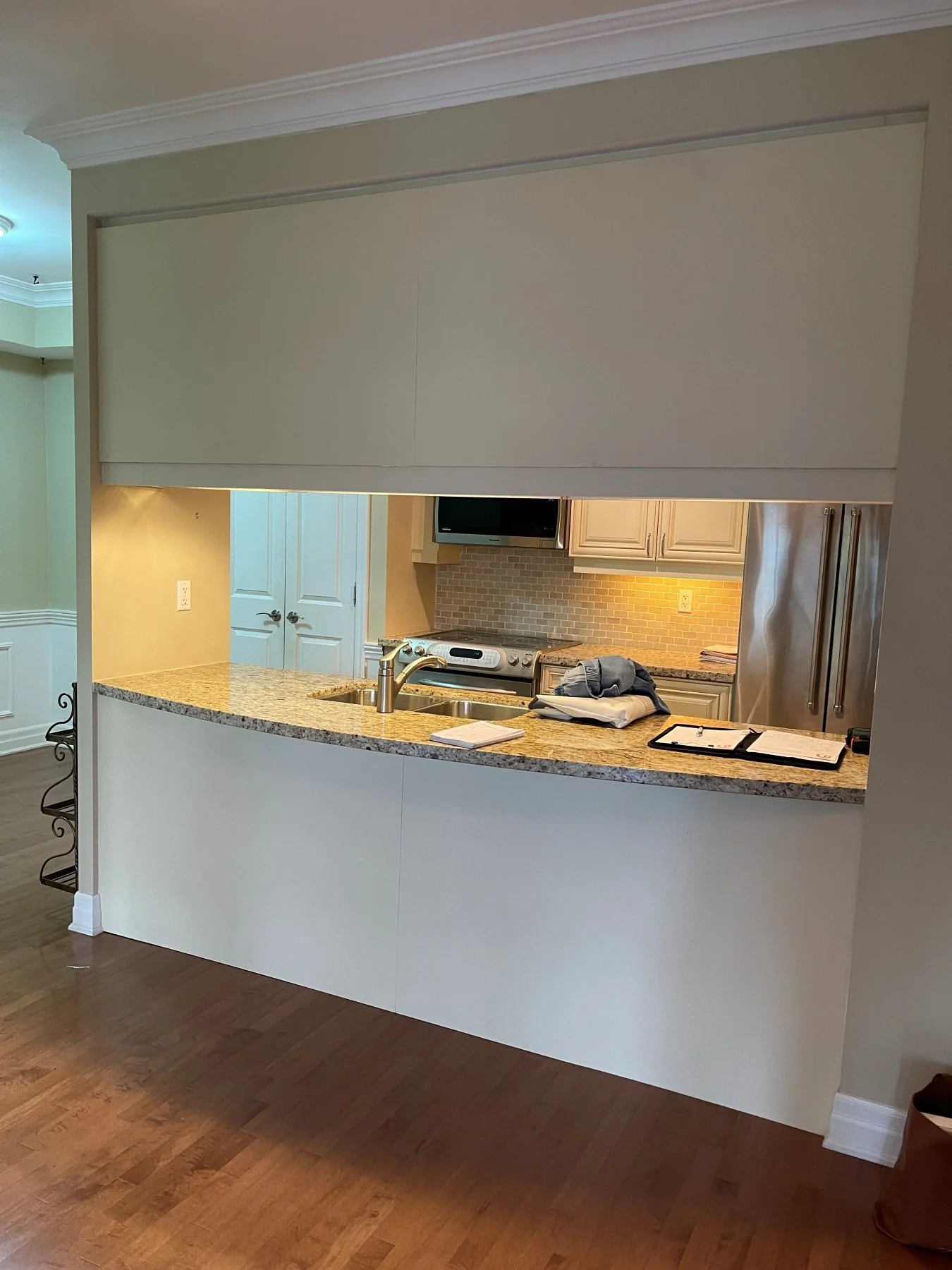 Etobicoke kitchen before the renovation, closed off behind a wall with a small pass-through