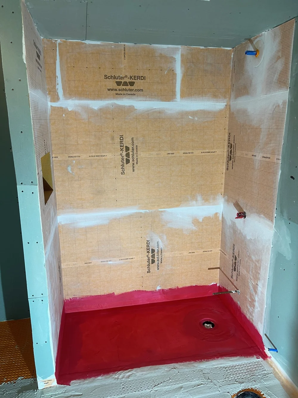 Shower walls and floor waterproofed with membrane before tiling in an Etobicoke bathroom