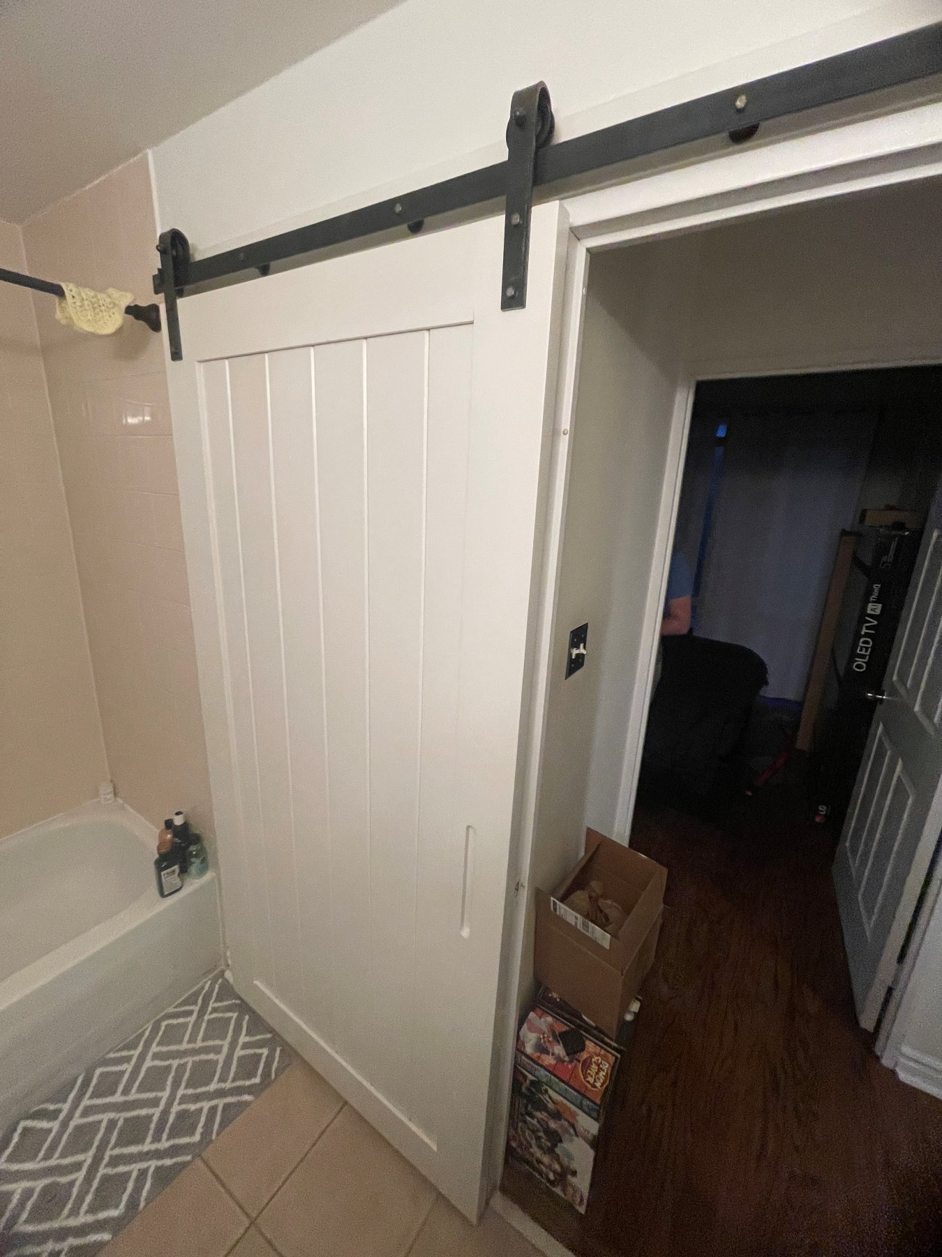 The old tub and barn door in the Distillery District condo bathroom before the renovation
