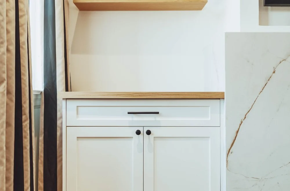 Built-in cabinet next to the marble fireplace surround