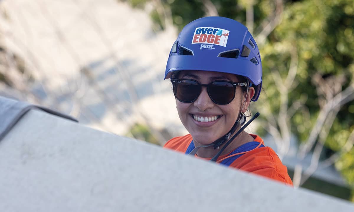 Over the Edge participant smiling in safety gear
