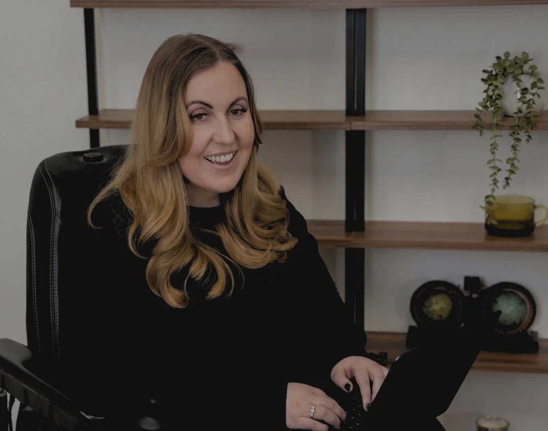 Rachel at work on her laptop in her office