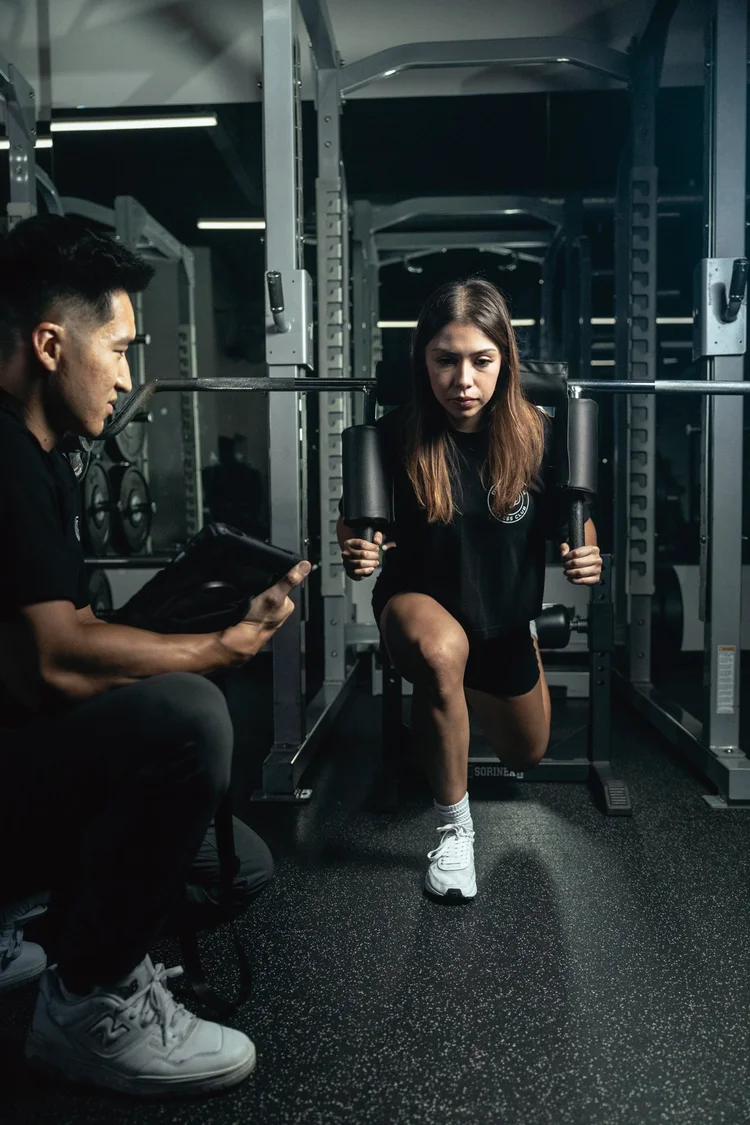 Women's safety bar split squat coaching with a personal trainer in Costa Mesa, CA