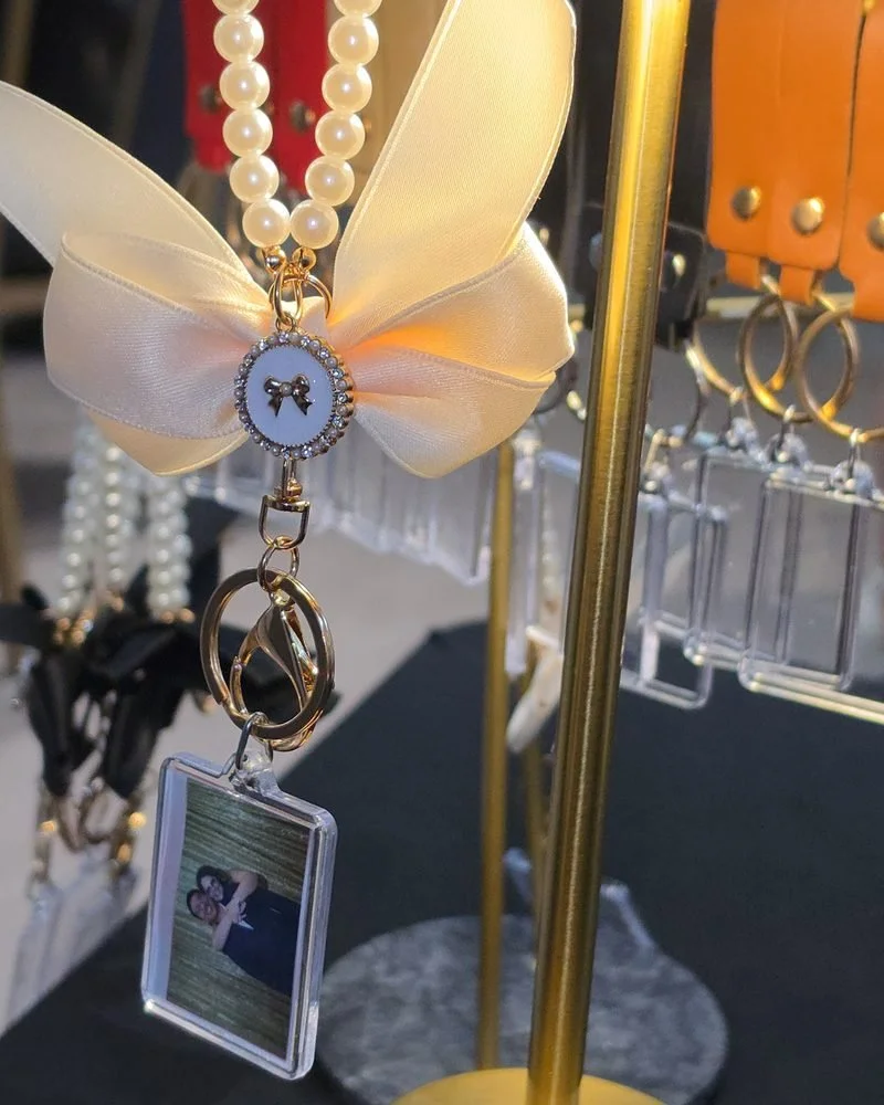 A finished pearl and bow photo keychain with a guest's photo inside