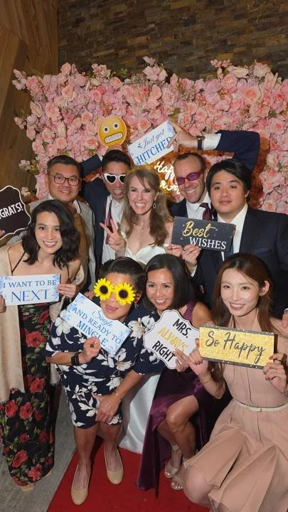 Wedding guests holding signs and props