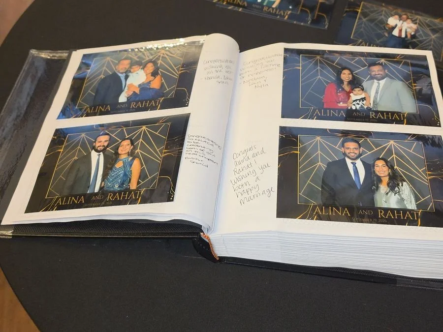 An open keepsake album filled with printed photos and handwritten notes from guests