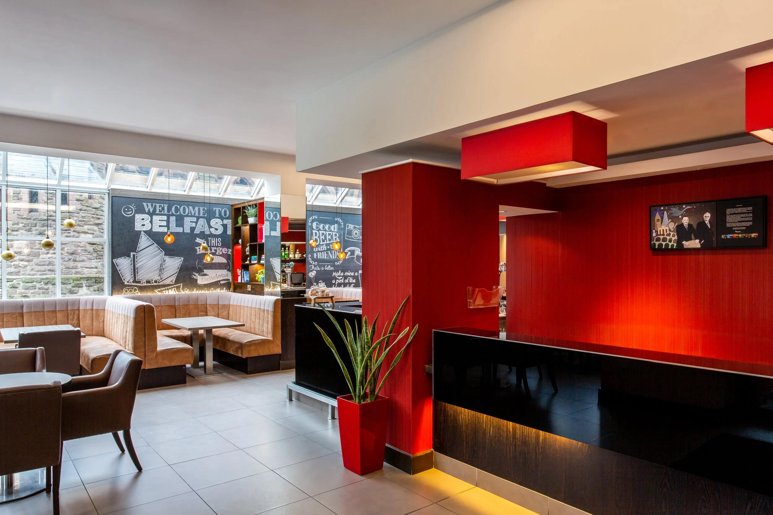Reception desk and bar seating area at Ibis Hotel Belfast | Hotel and hospitality photography by Sequoia Studios