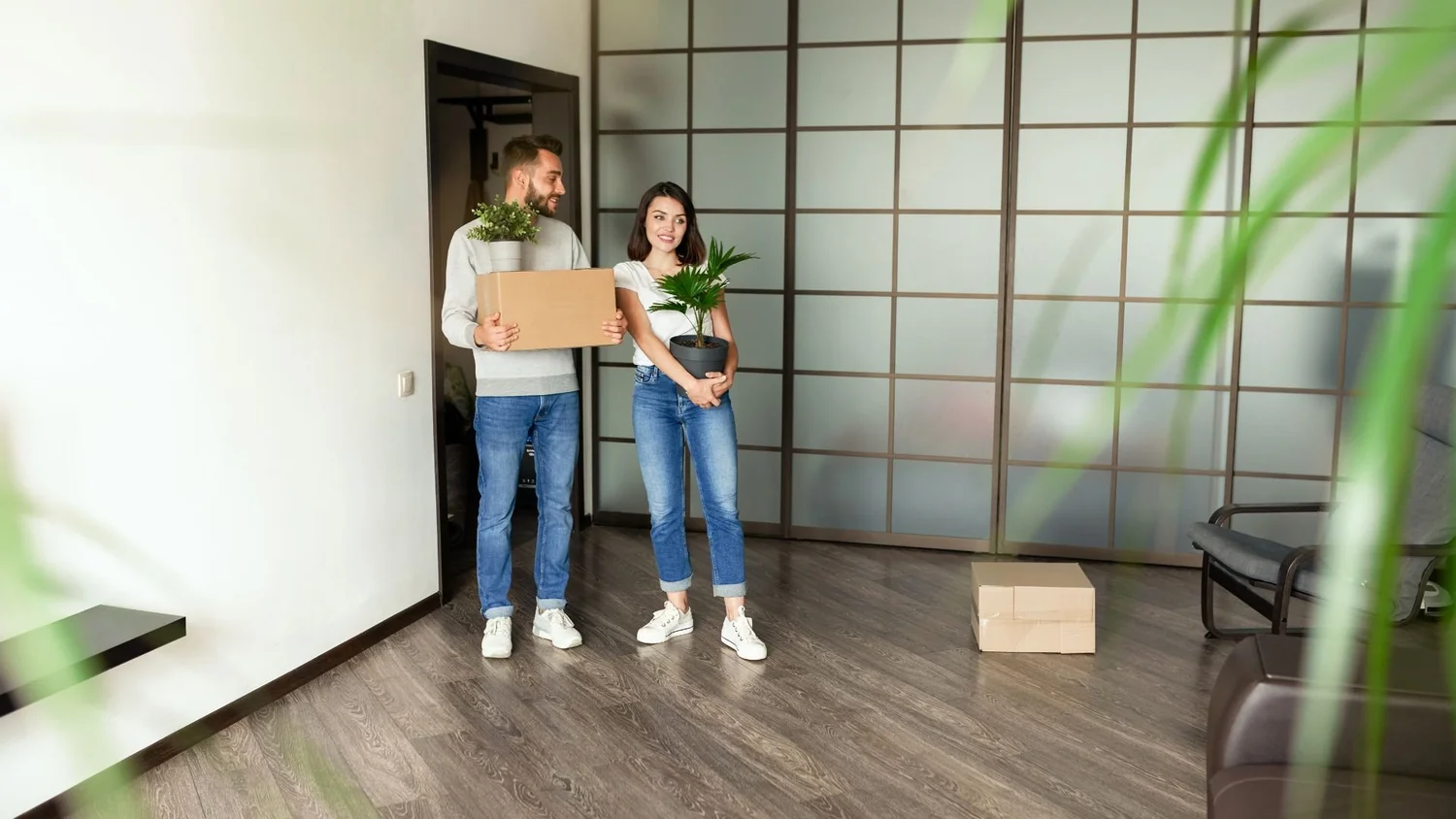 Couple carrying moving boxes into a newly rented Arizona home