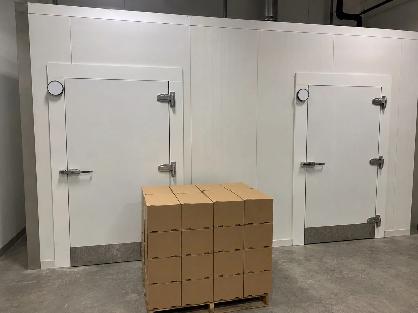 Insulated walk-in cooler panels during assembly by Titan Walk-In Coolers