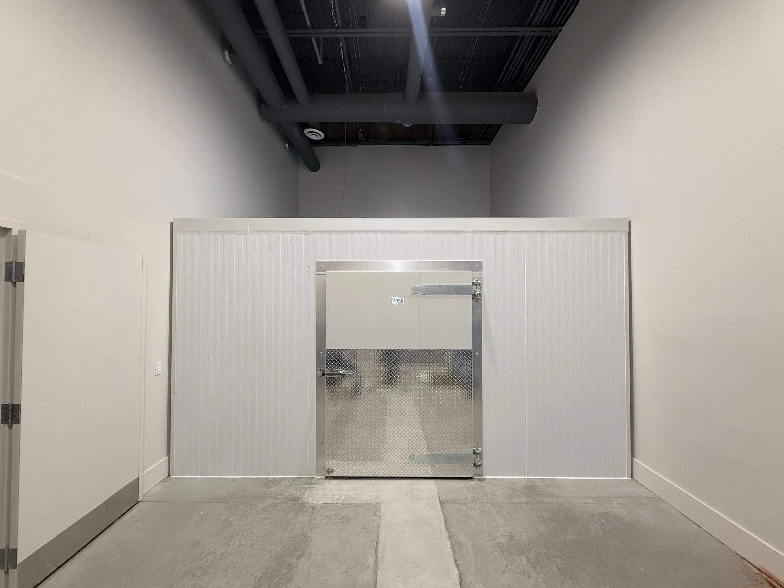 Finished Titan walk-in cooler installation with aluminum panel exterior in the GTA