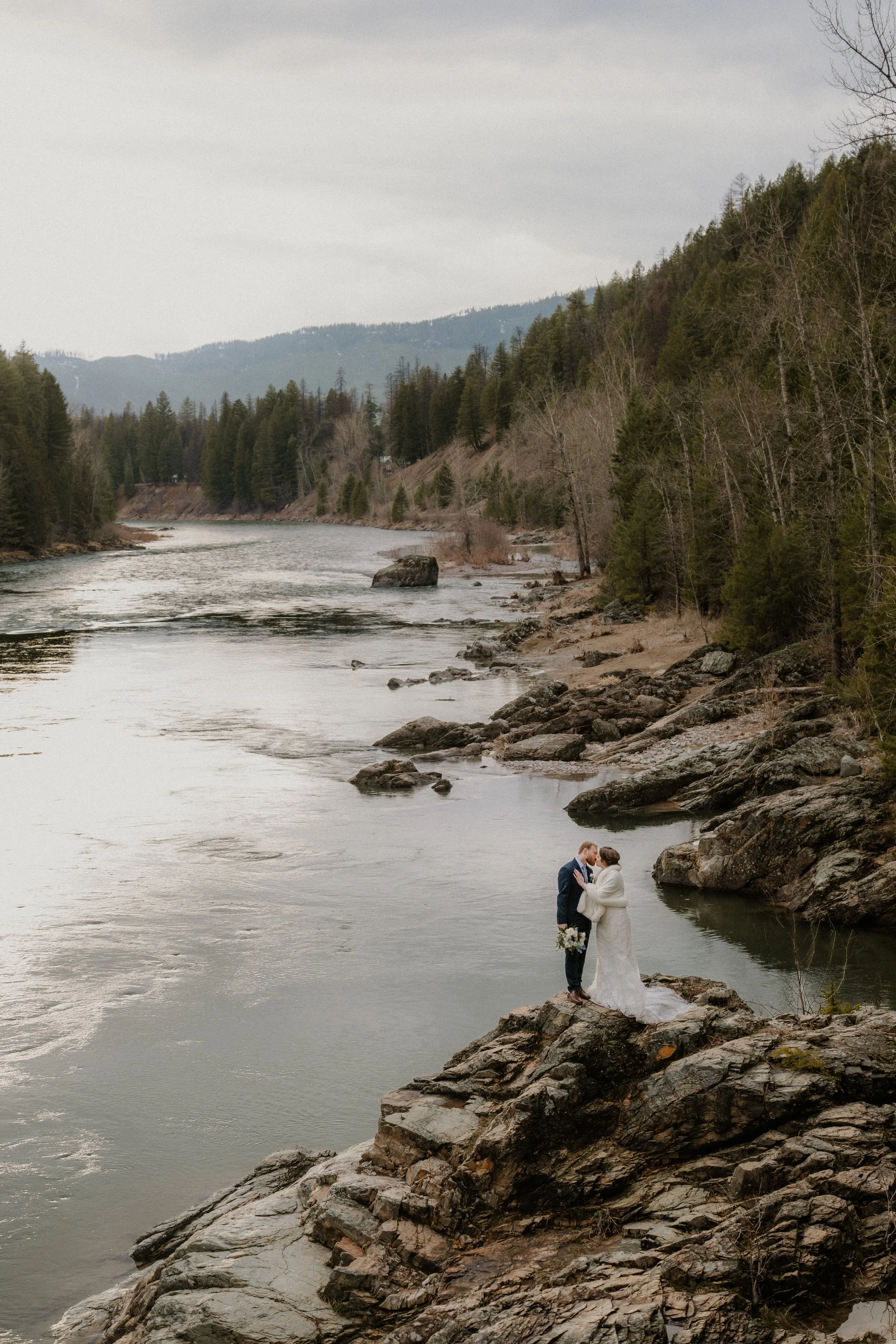 Couple portrait with a mountain backdrop at Many Glacier