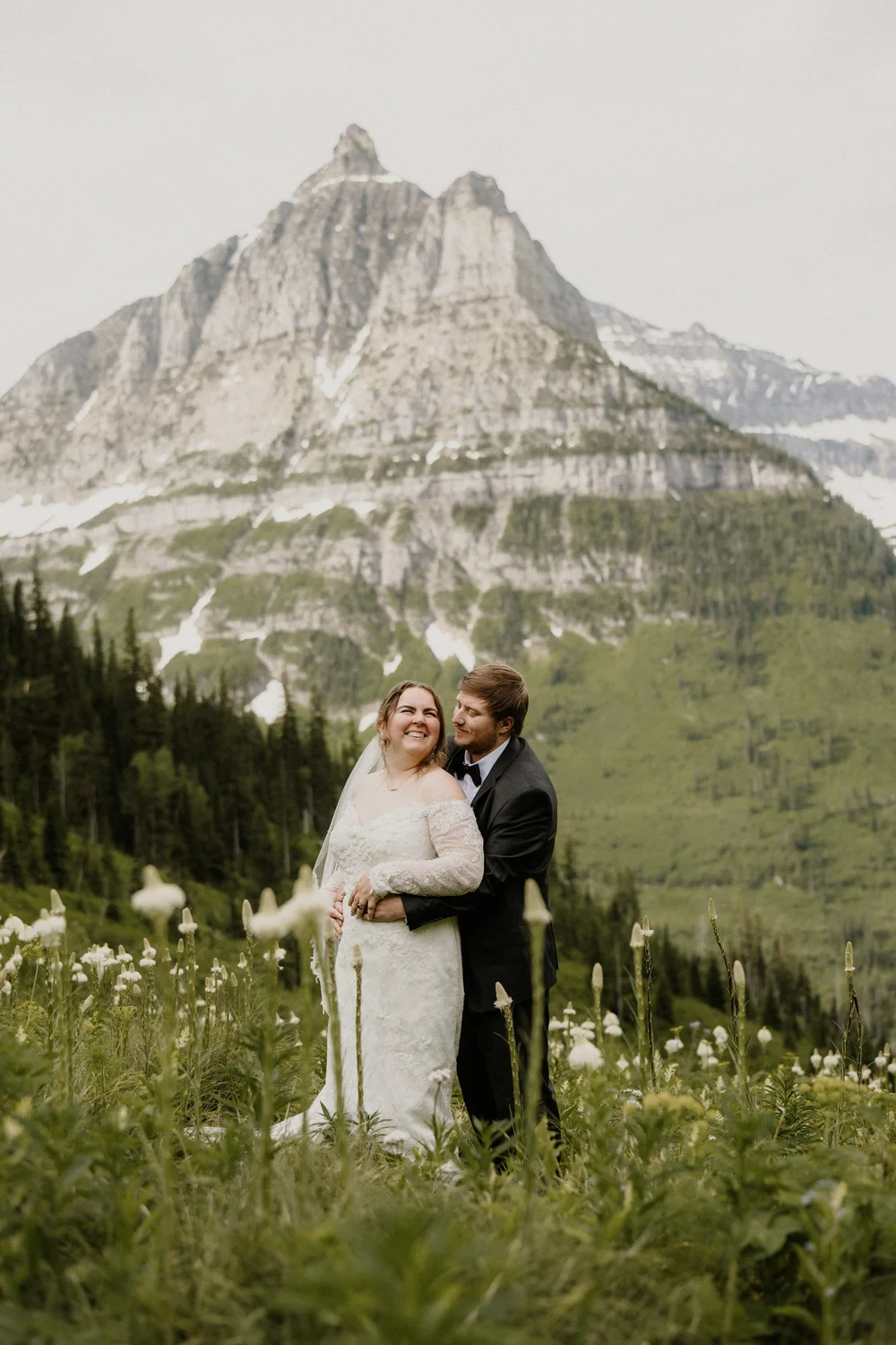 Maddie and Clay playing in the snow at Logan Pass after their elopement