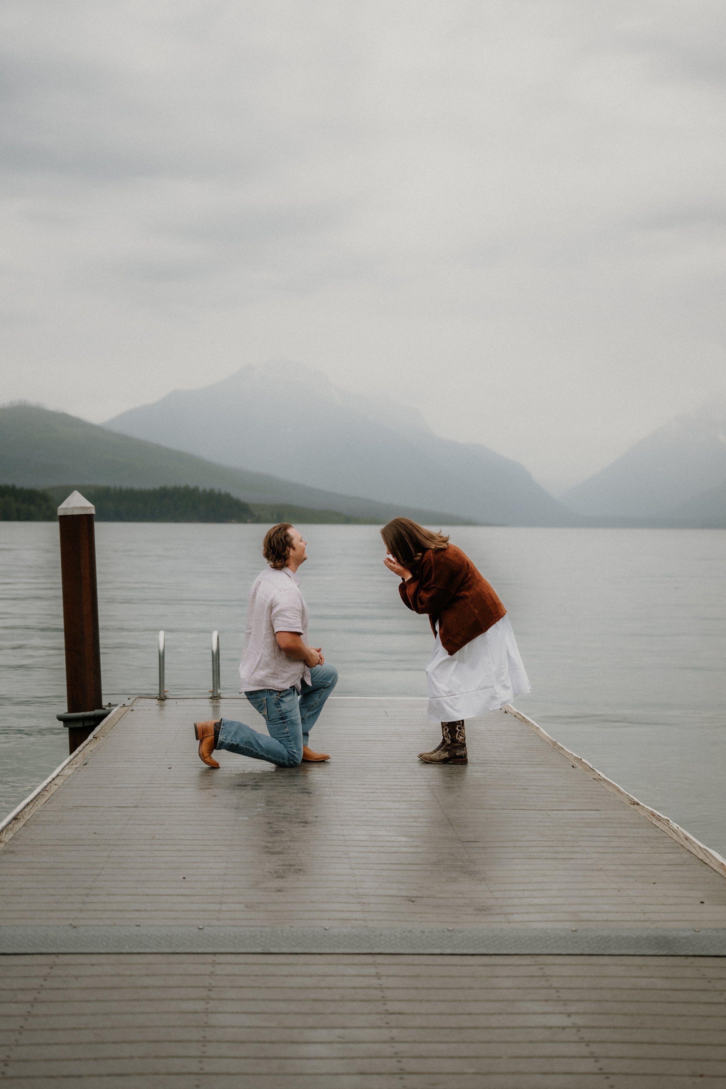 Engagement ring detail photo with rainy Lake McDonald and mountains in the background