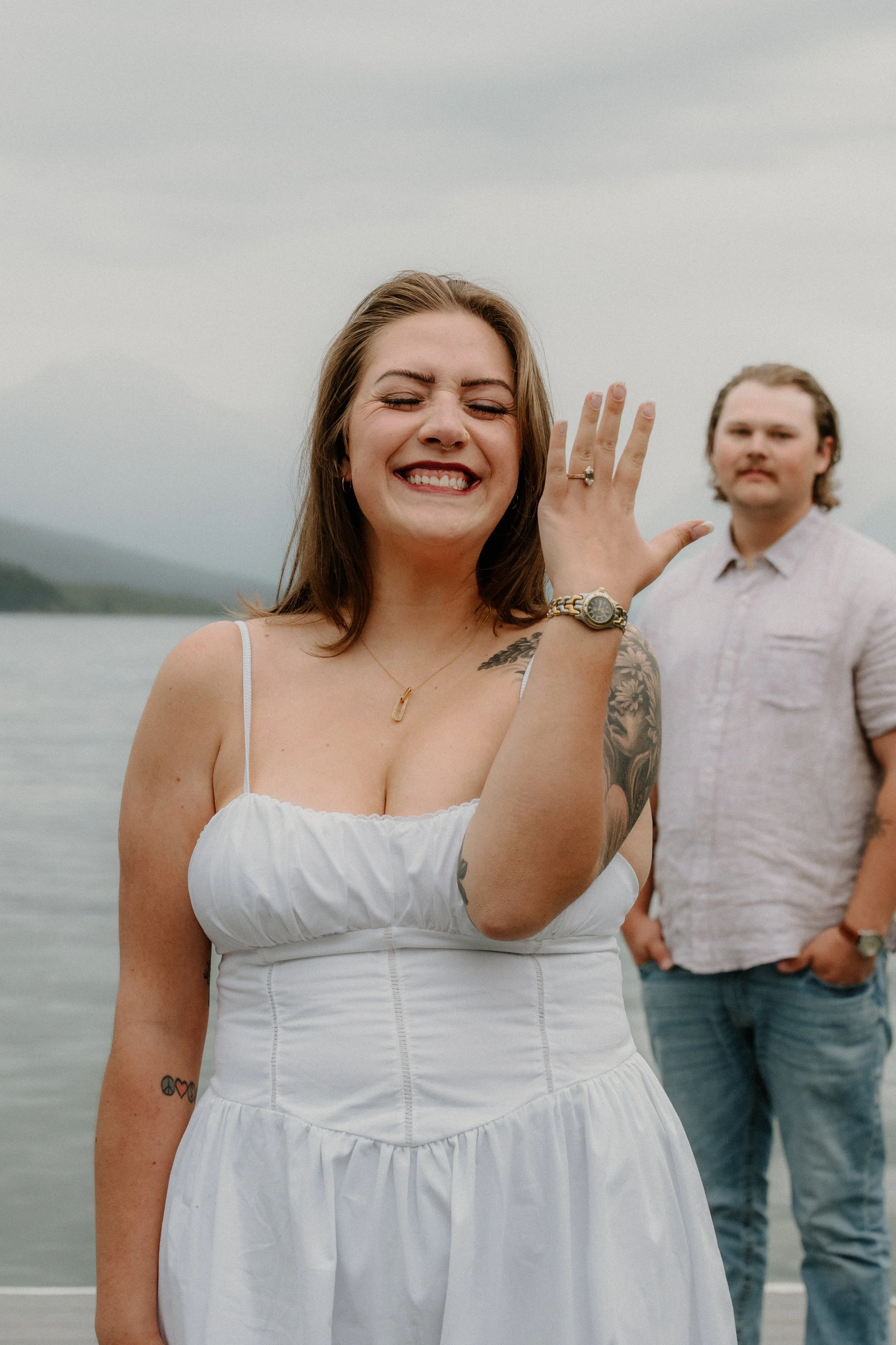 Jenica and Brenden portrait at the end of their rainy surprise proposal session in Glacier National Park
