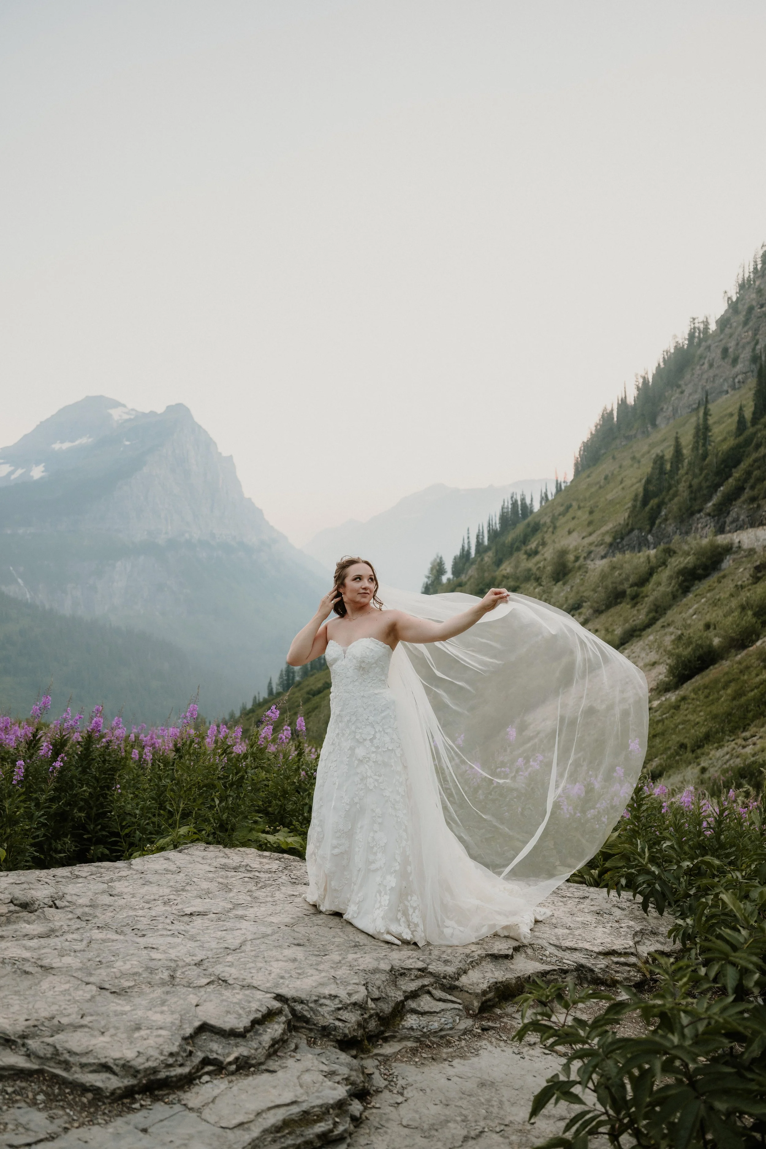 Bride and groom at Big Bend with the Glacier National Park valley behind them