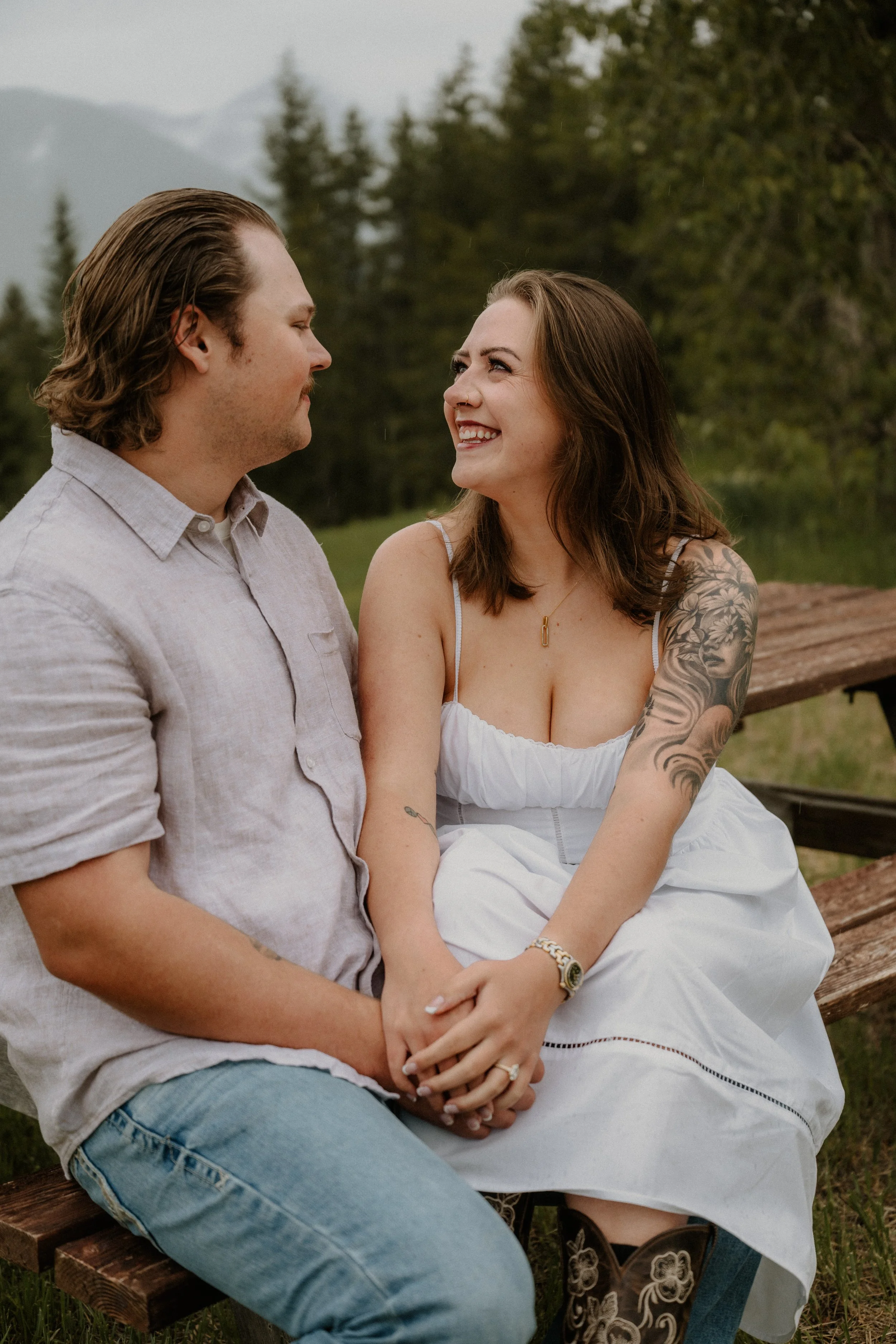 Couple portraits on the Apgar dock after a surprise proposal photographed by a Glacier National Park proposal photographer