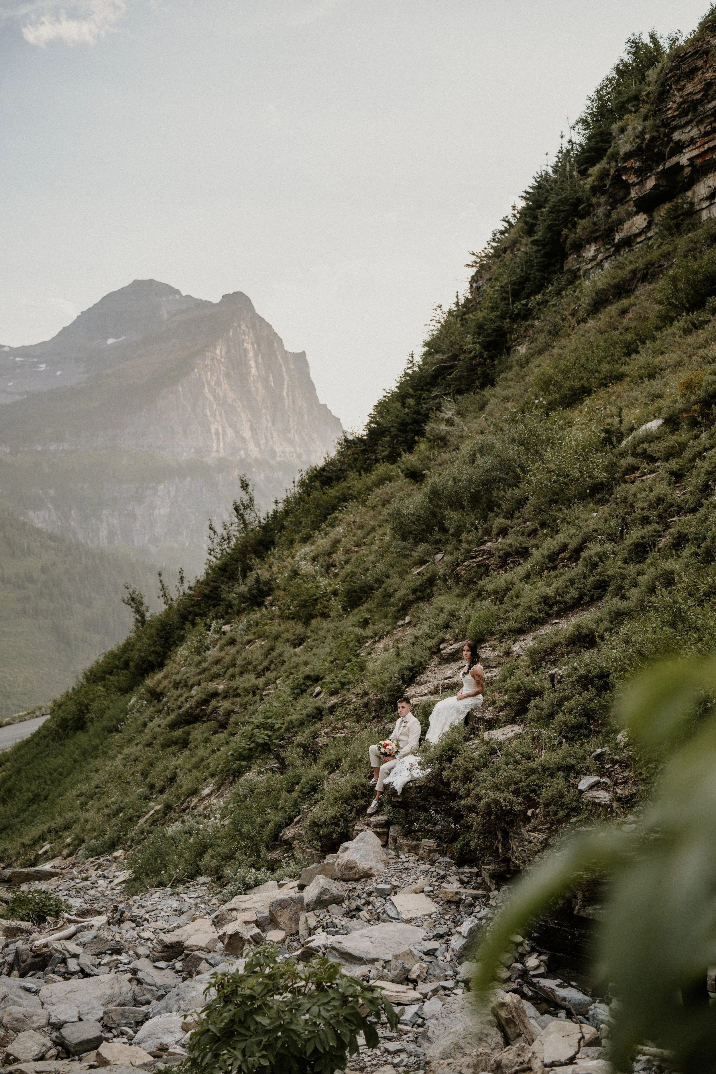 Couple reading vows on a trail covered in golden larch needles in Glacier National Park