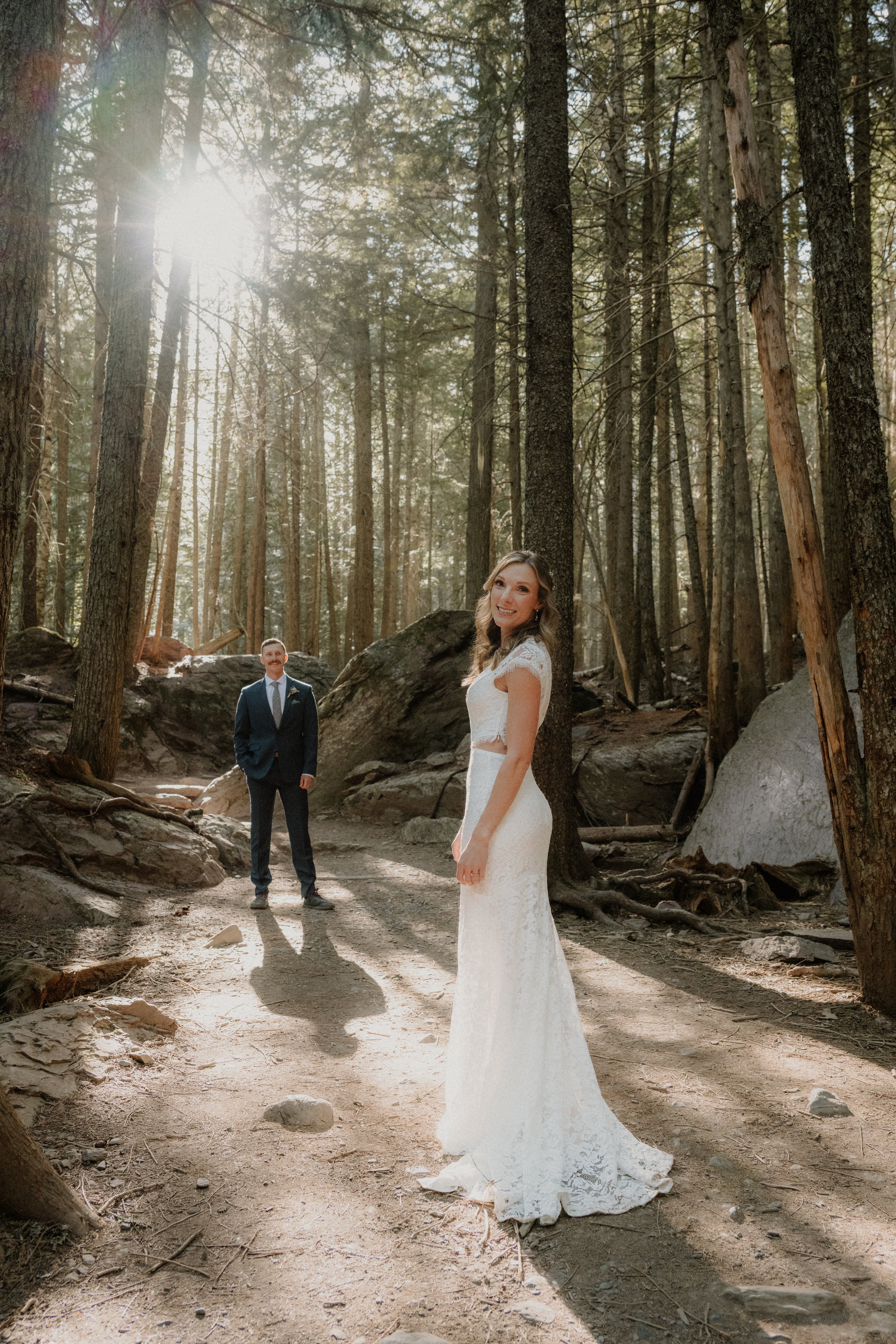 Bride and groom hiking through Glacier National Park to Avalanche Lake
