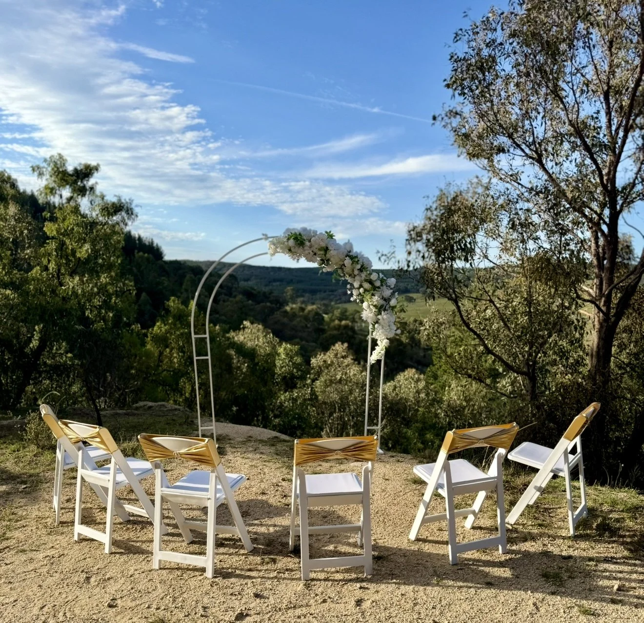 Styled ceremony setup with arbour and chairs