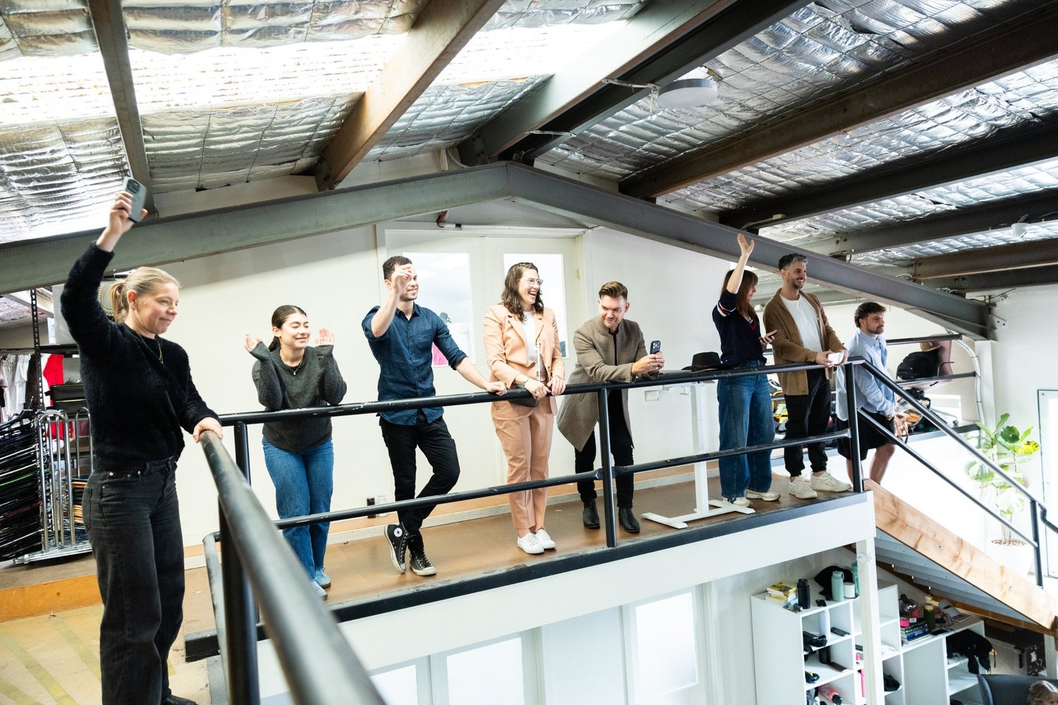 The team watching from the mezzanine above the studio