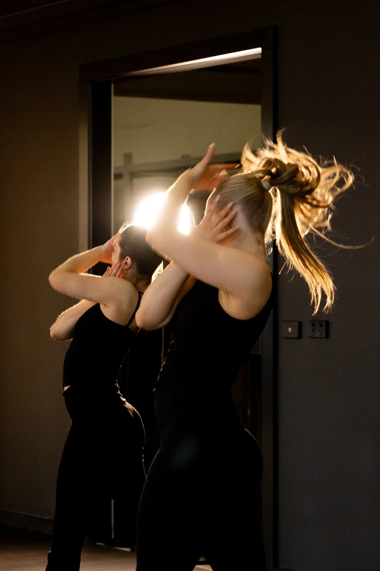 Performers getting ready under globe lights in the dressing room