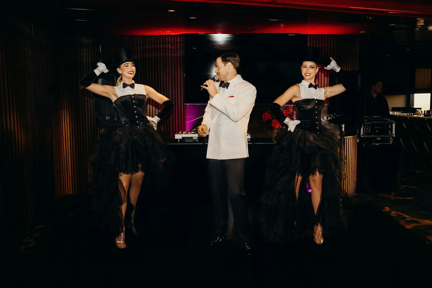 A cabaret feature with top-hat dancers and a vocalist in white