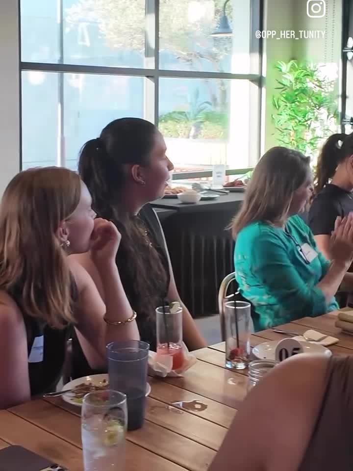 Women seated at a table listening at the oppHERtunity launch event