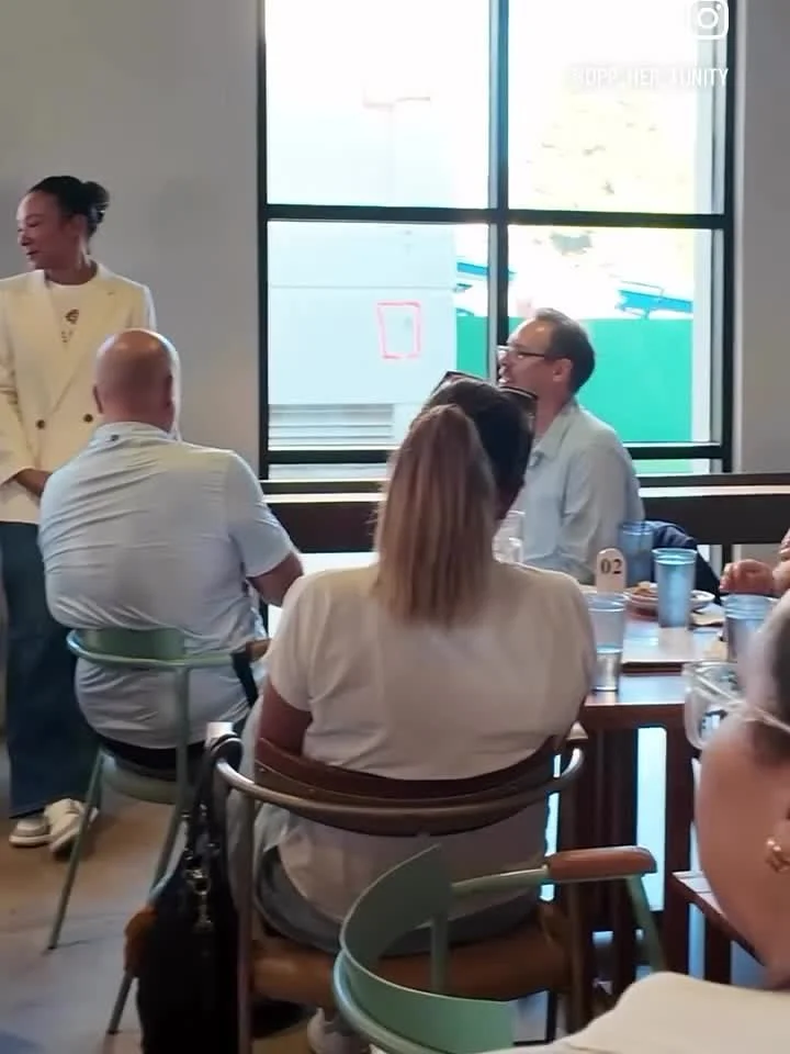 Seated guests listening by the windows at an oppHERtunity event