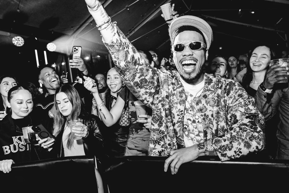 Black-and-white shot of a cheering party crowd
