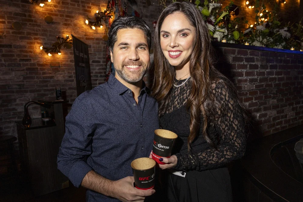 Guests posing with branded drinks