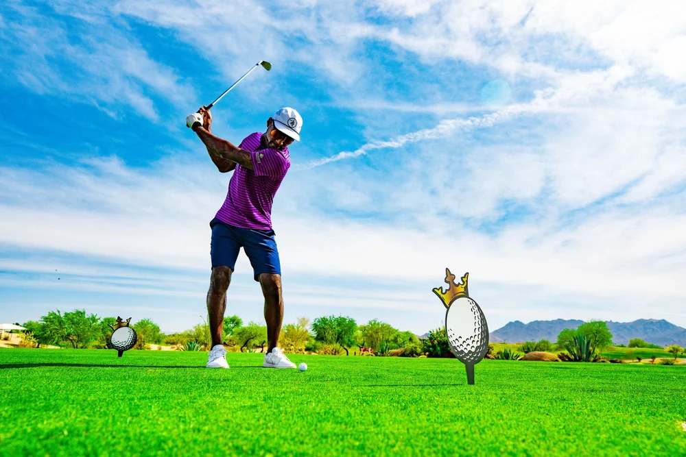 Golfer teeing off