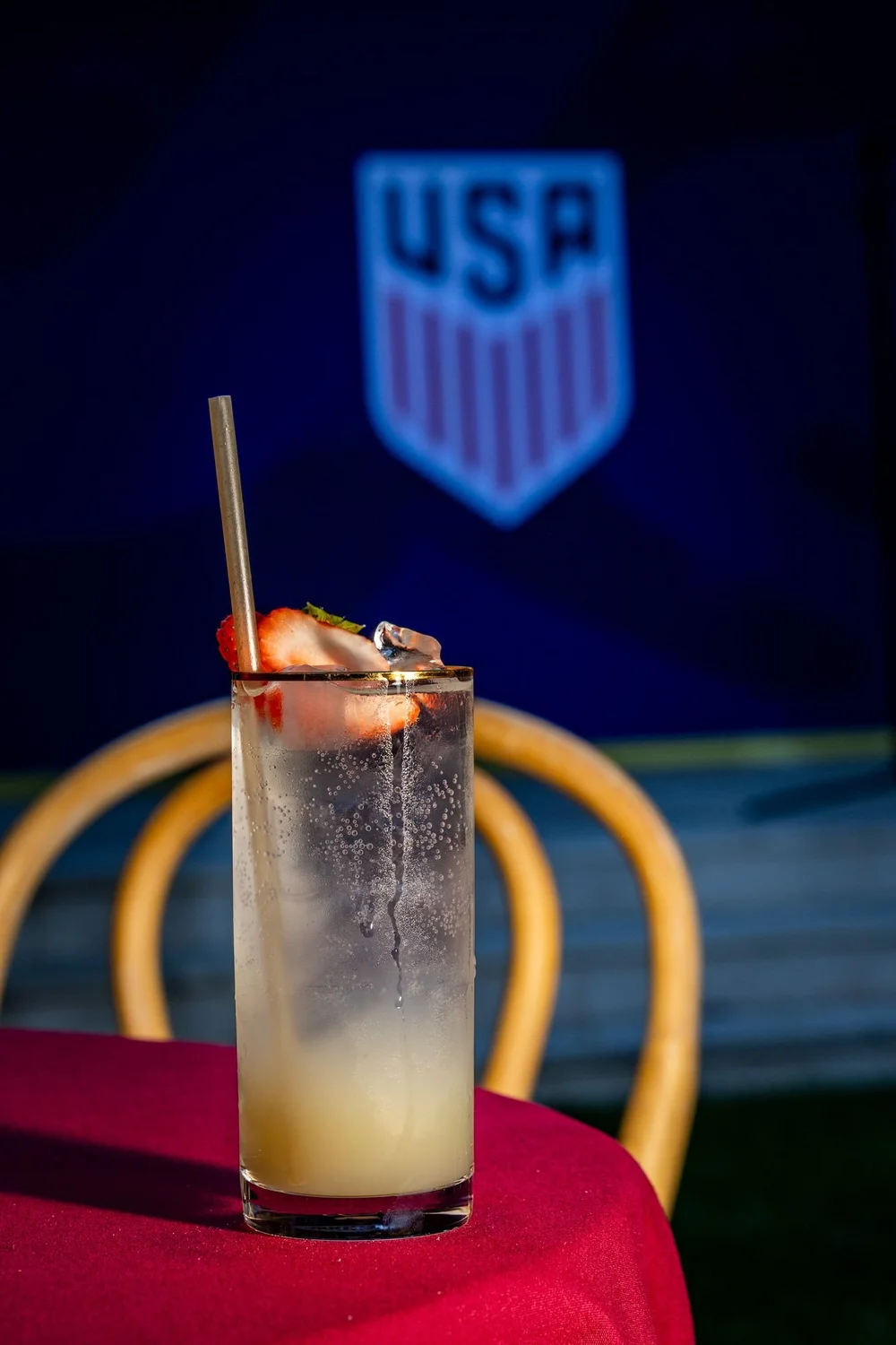 Signature cocktail in front of a team crest