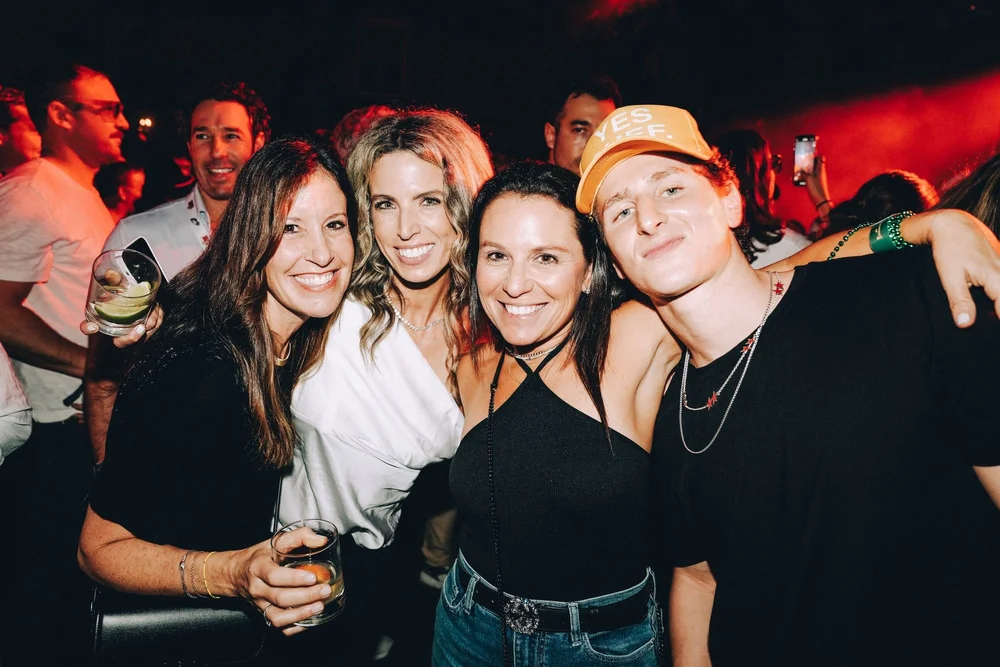 Friends posing together at a night party