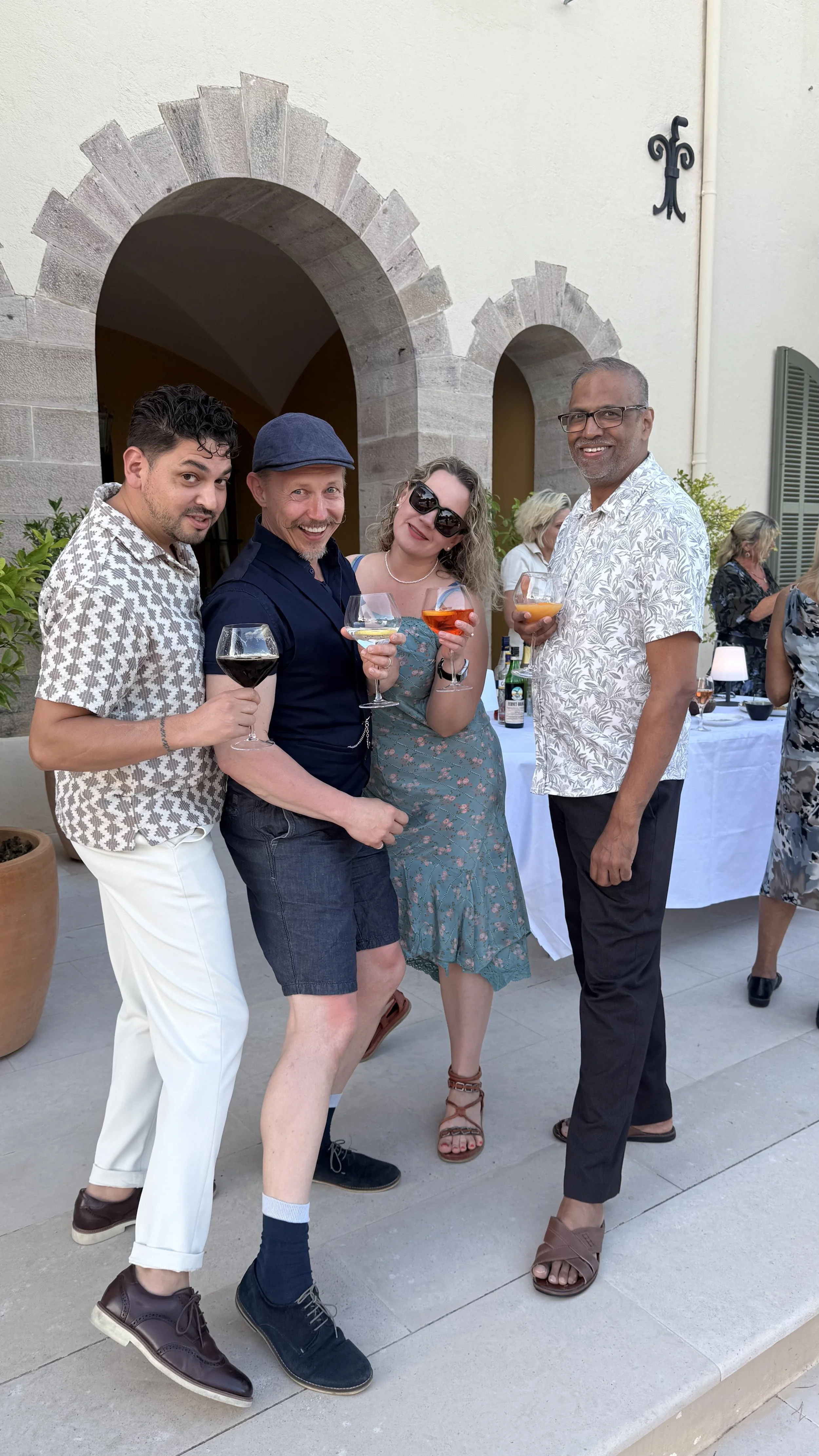 Retreat guests smiling with Andrés during aperitivo by the pool