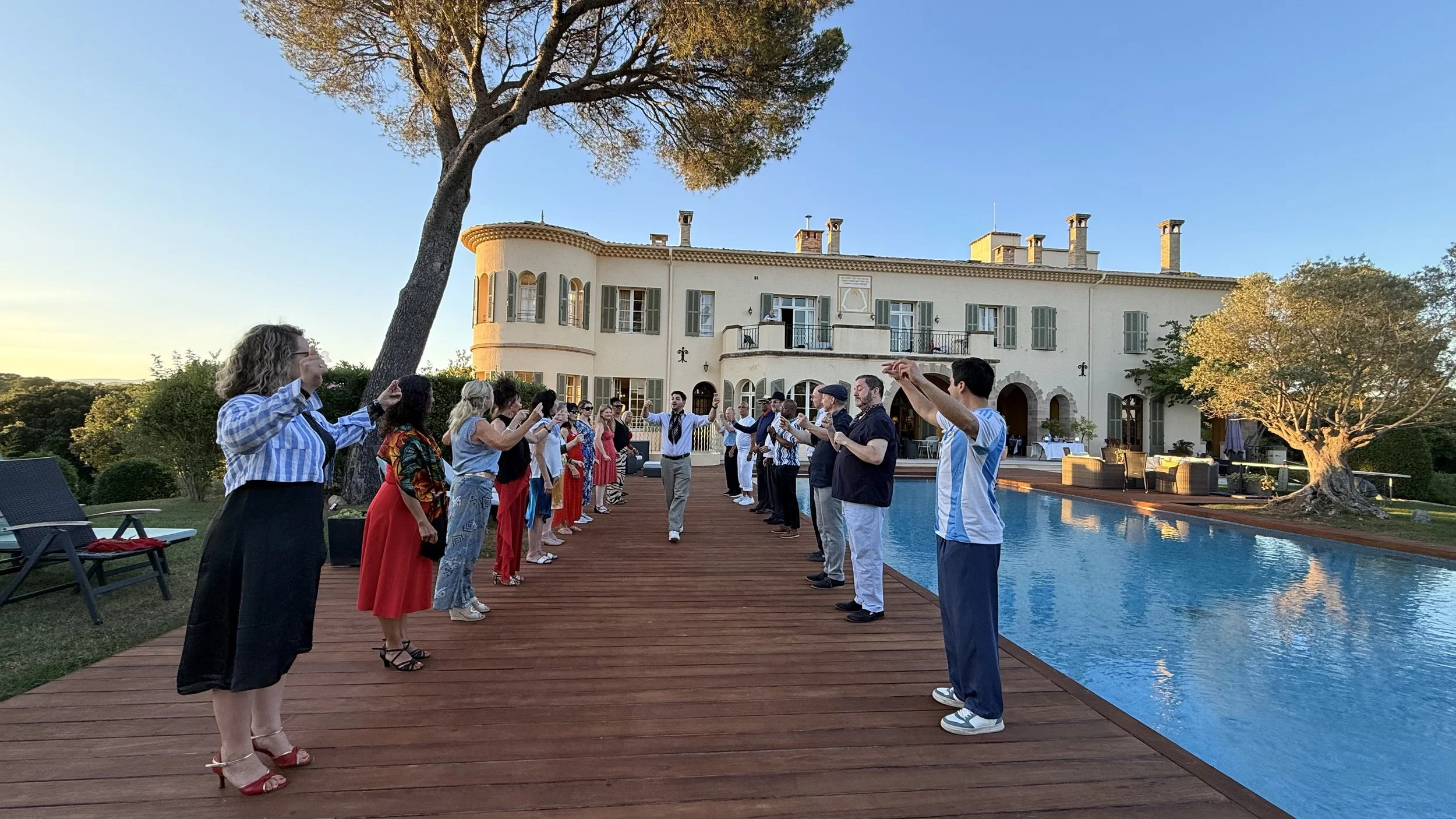 Andrés teaching Chacarera Argentine folklore by the pool at the France Retreat